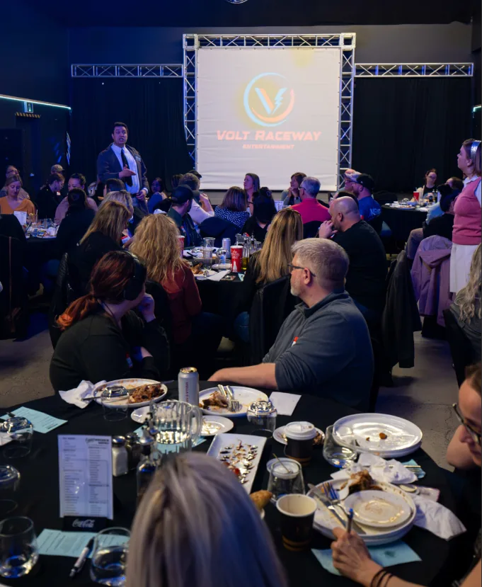 Guests enjoying a group dinner and presentation at Volt Raceway