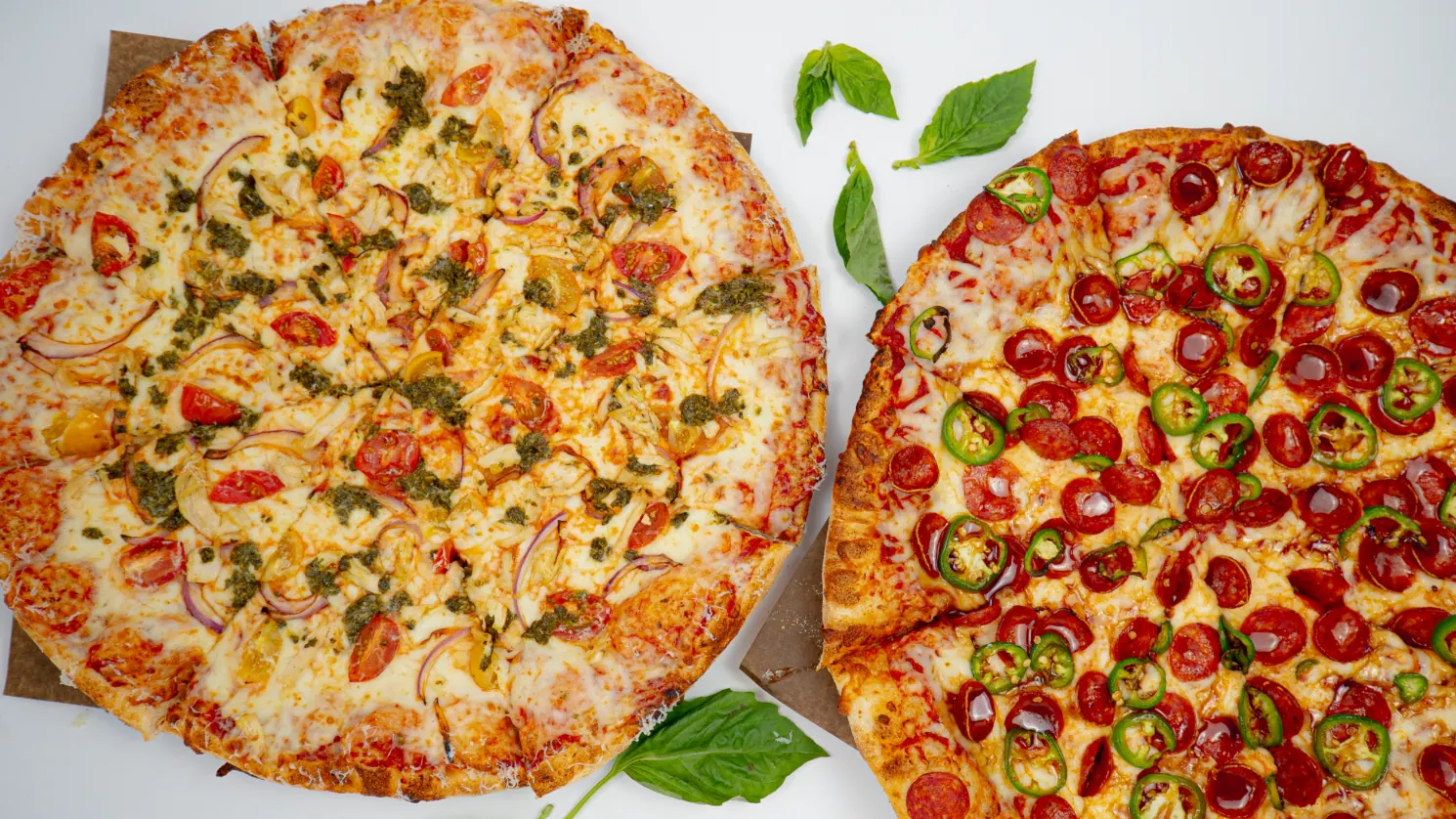 Two Eddie's stone-fired pizzas with a variety of toppings