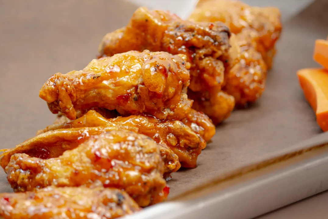 Close-up of sauced Eddie's chicken wings