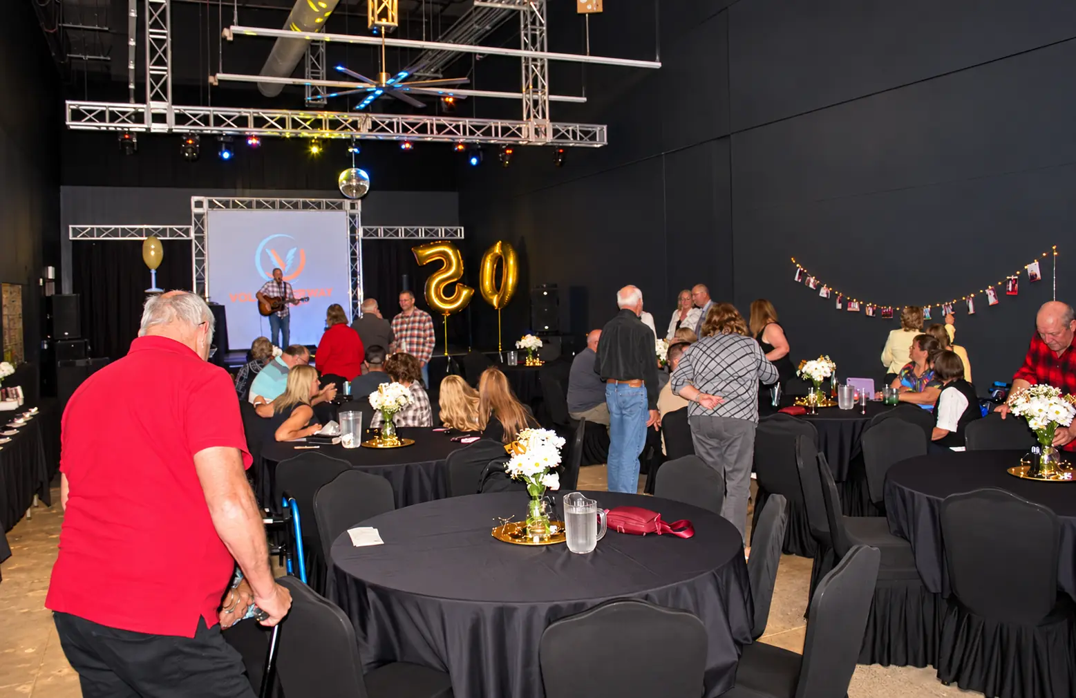 Guests at a Volt Raceway banquet celebration with tables and live music
